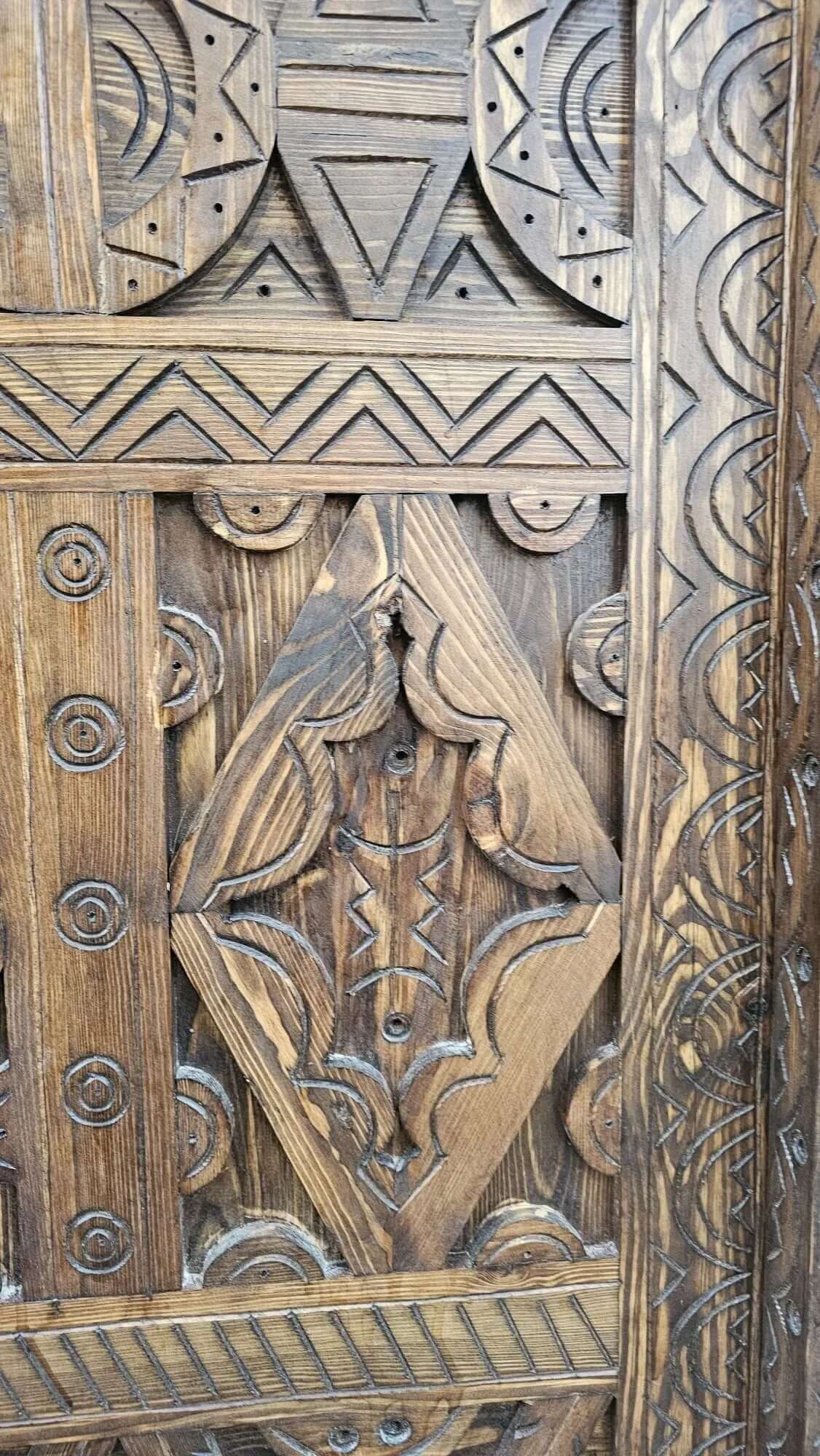 AtlasMuseCrafts antique Moroccan door, natural wood with intricate Berber carving. Features geometric patterns and a rustic finish.