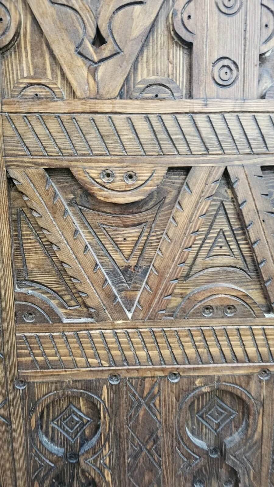 AtlasMuseCrafts antique Moroccan door, natural wood with intricate Berber carving, geometric patterns, rustic finish.