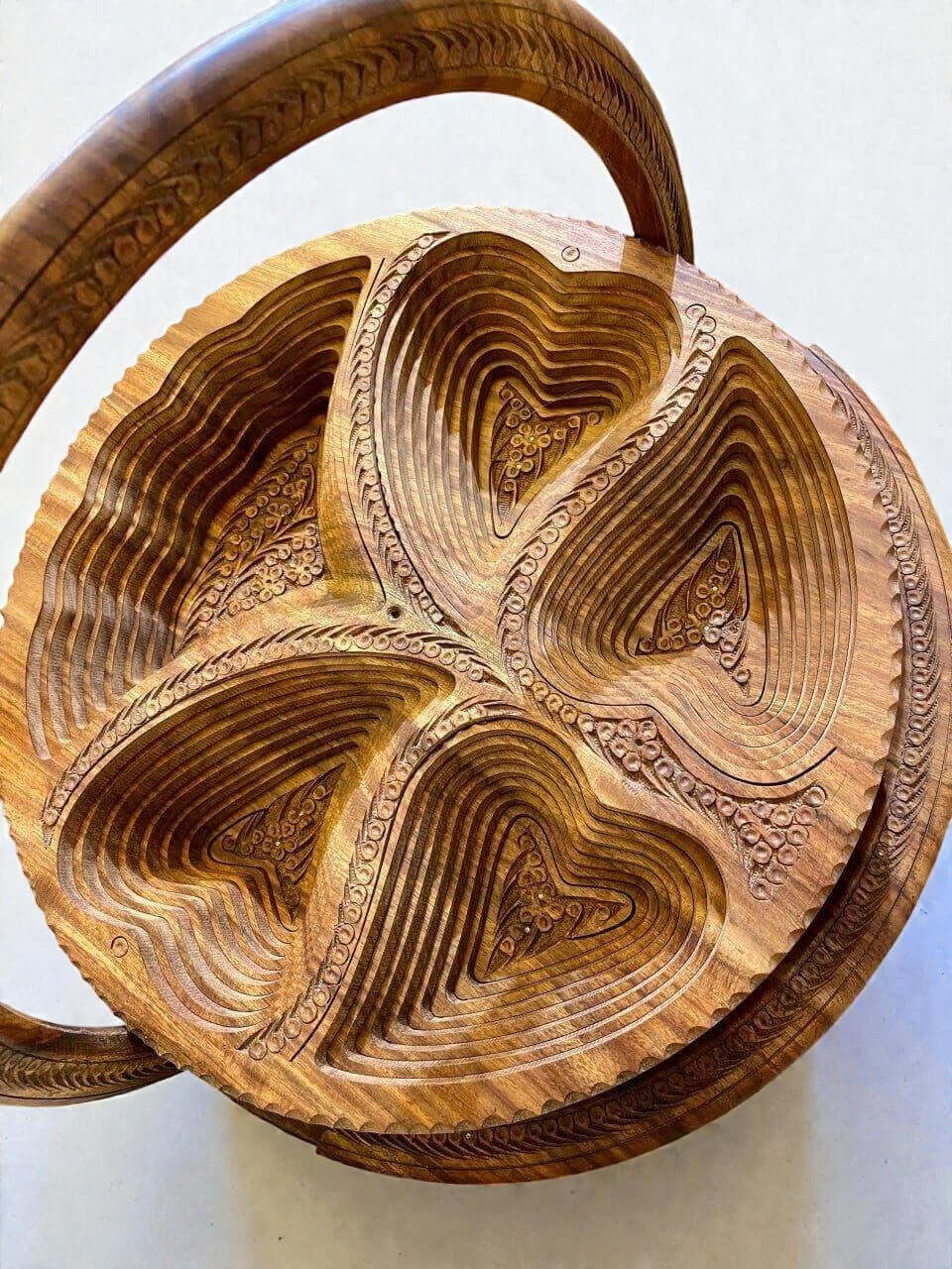 Handmade folding wood fruit basket with carved floral details and handle