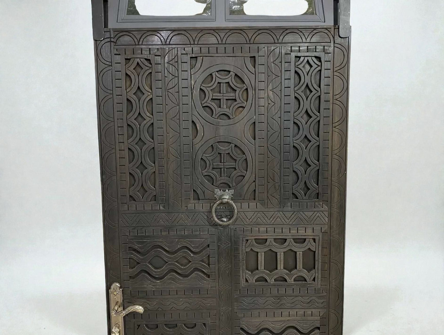 AtlasMuseCrafts dark wood door with intricate traditional floral carvings and a circular door knocker.