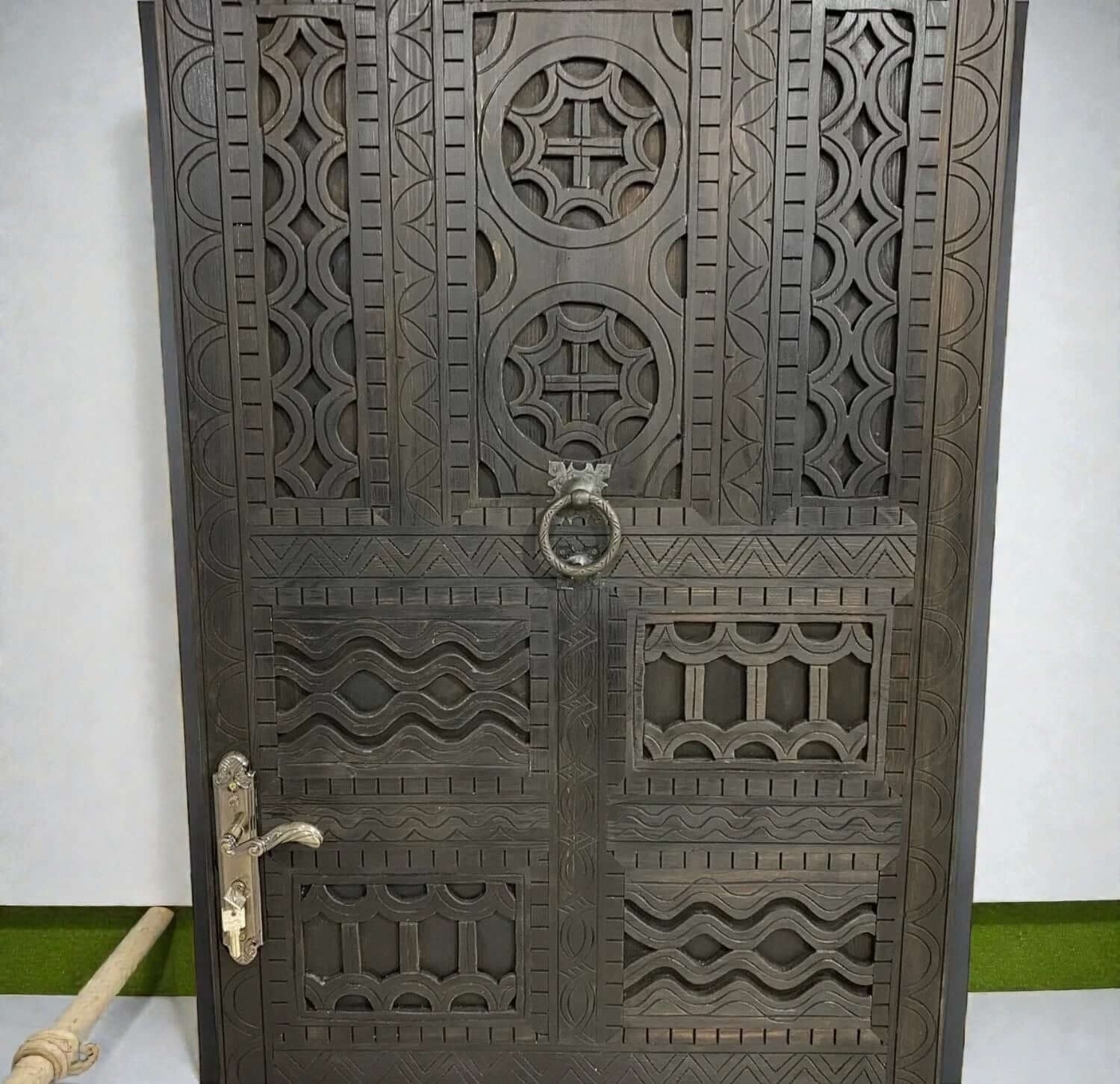 AtlasMuseCrafts dark wood door with intricate traditional floral carvings and brass hardware.