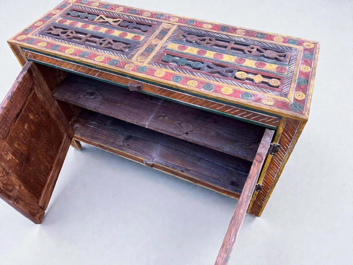 AtlasMuseCrafts handmade wooden cabinet with colorful Berber carvings and rustic boho style. Features open doors revealing shelves.