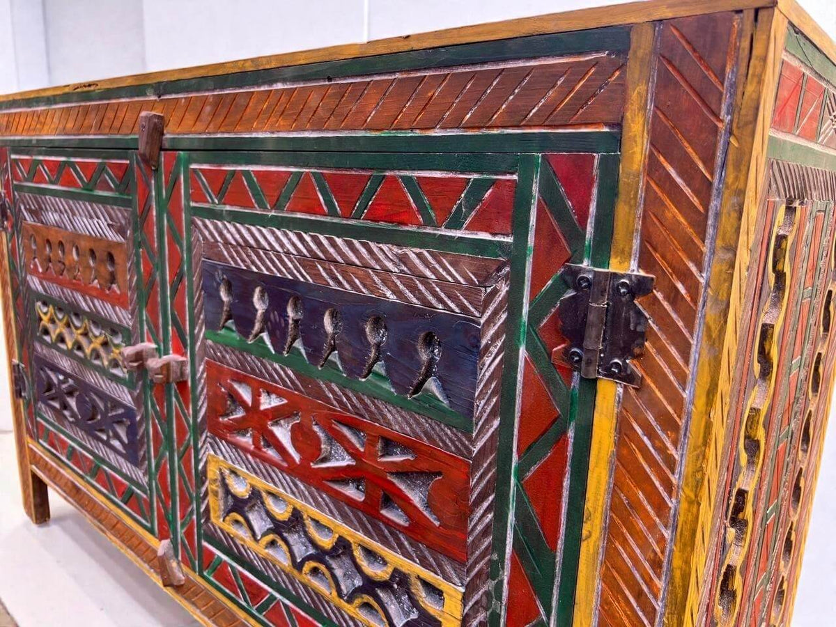 AtlasMuseCrafts handmade wooden cabinet with colorful Berber carvings and rustic boho style. Features intricate patterns, red, green, yellow, and blue accents.