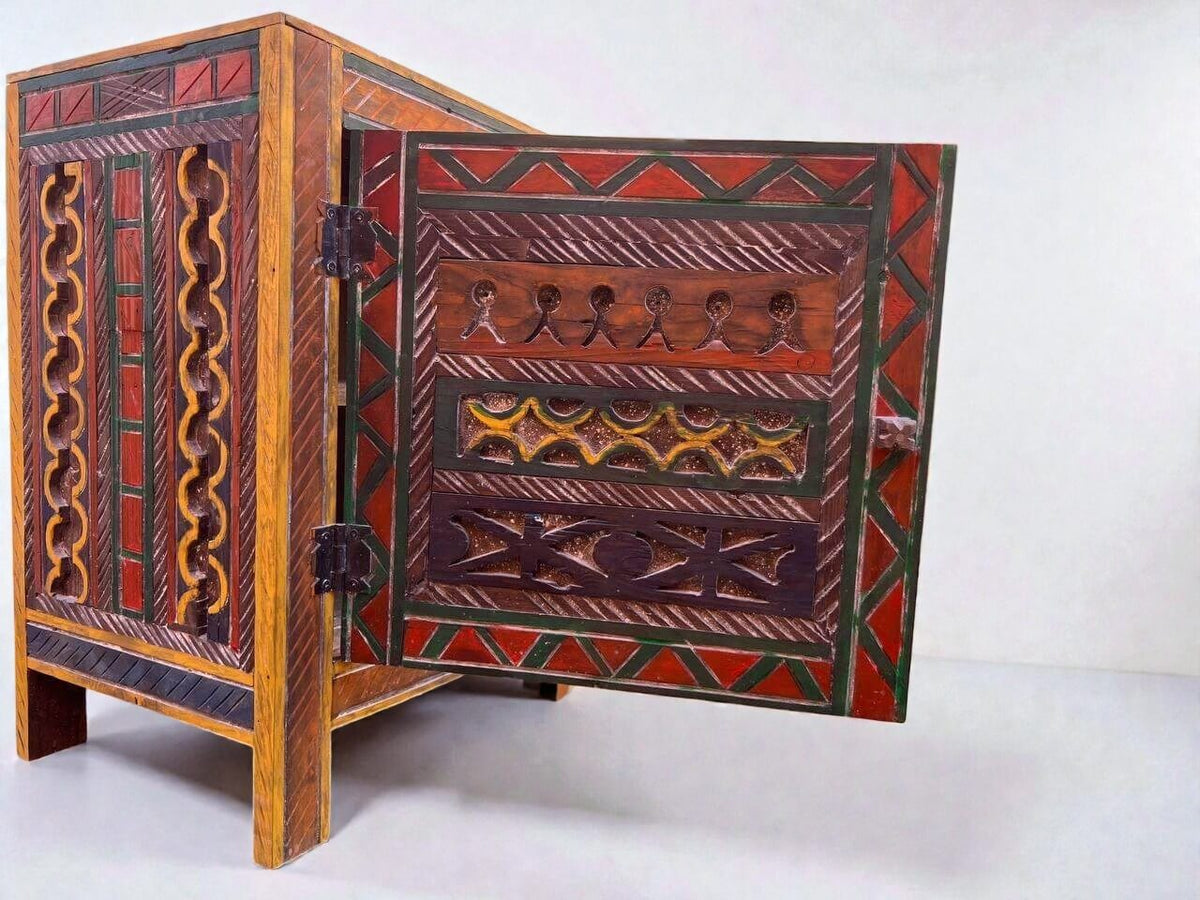 AtlasMuseCrafts handmade wooden cabinet with intricate Berber carvings and colorful geometric patterns. Features hand-painted details in red, green, and orange.