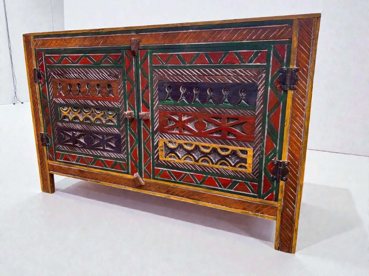 AtlasMuseCrafts handmade wooden cabinet with intricate Berber carvings in red, green, yellow, and blue. Features two doors and rustic boho style.