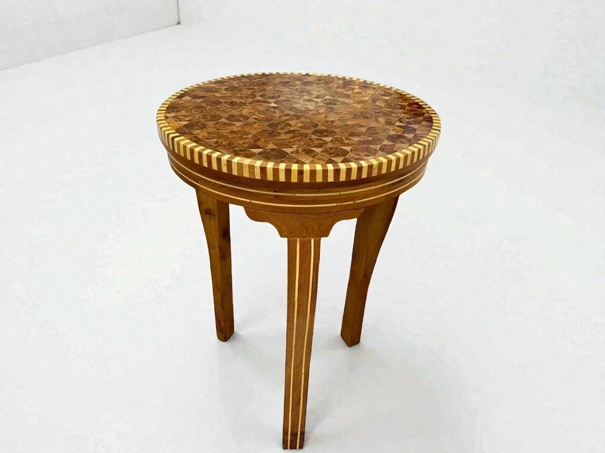AtlasMuseCrafts handmade round wooden coffee table with intricate mosaic inlay top and carved legs, Moroccan accent style.