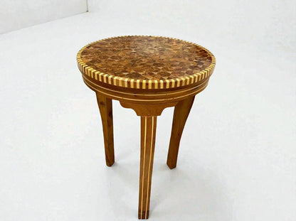 AtlasMuseCrafts handmade round wooden coffee table with intricate mosaic inlay top and carved legs, Moroccan accent style.
