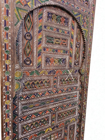 AtlasMuseCrafts Moroccan antique style door with intricate hand-carving and colorful geometric patterns on natural wood.