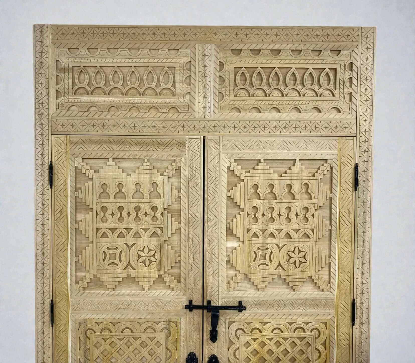 AtlasMuseCrafts handcrafted Moroccan carved wood double door with intricate Berber geometric patterns and black hardware.