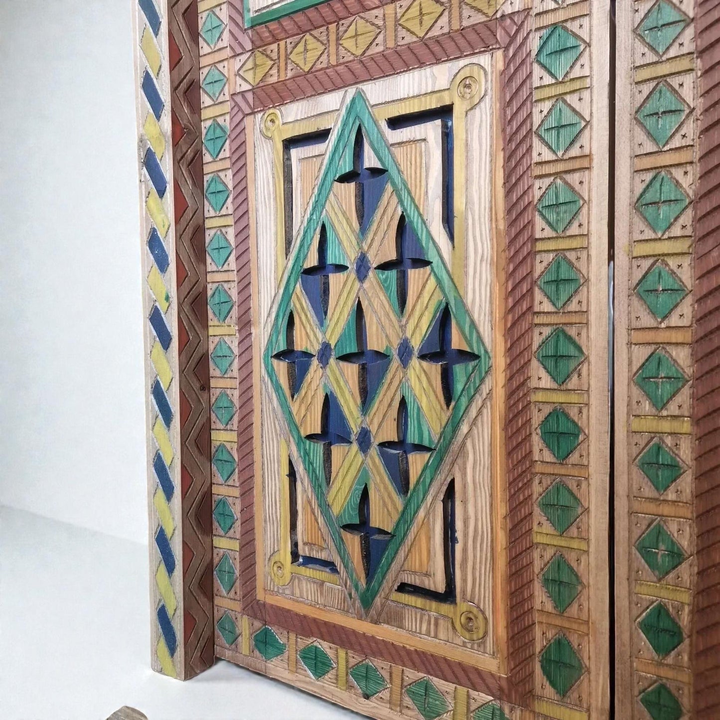AtlasMuseCrafts hand-painted multicolor Moroccan door with geometric carving in wood. Features blue, green, yellow, and red pigments.