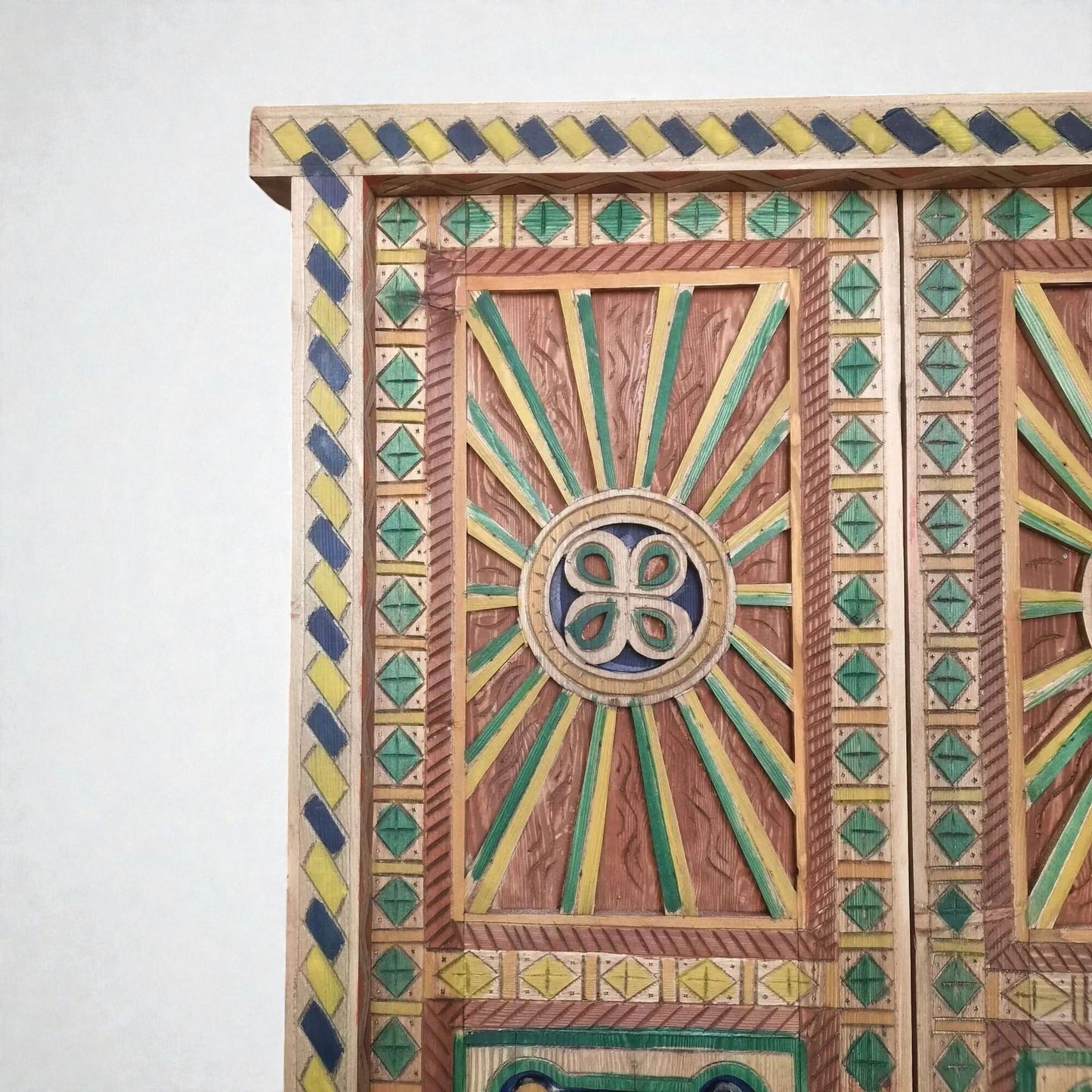 AtlasMuseCrafts hand-painted multicolor Moroccan door with geometric carving in wood. Features sunbursts and diamond patterns.