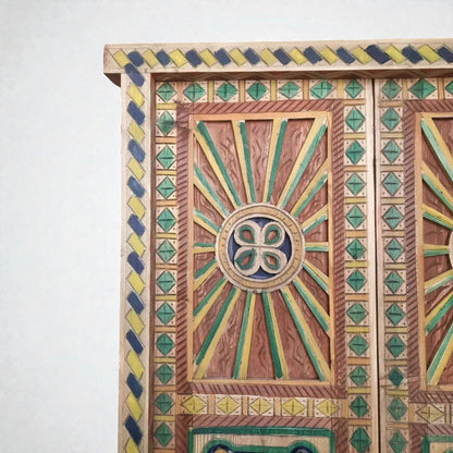 AtlasMuseCrafts hand-painted multicolor Moroccan door with geometric carving in wood. Features sunbursts and diamond patterns.