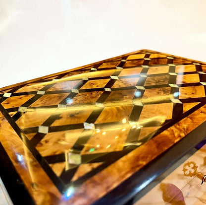 AtlasMuseCrafts handmade Moroccan Thuya wood jewelry box with polished amber burl grain and geometric inlay details.