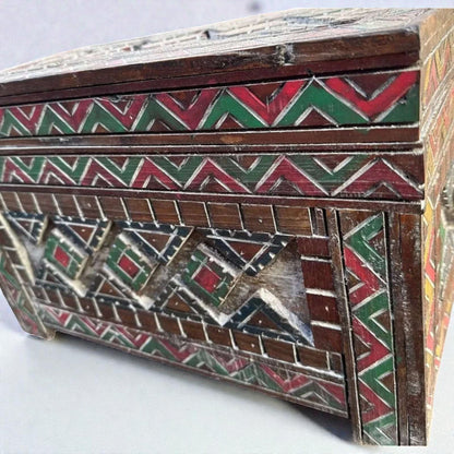 AtlasMuseCrafts custom Moroccan wood cabinet with hand-carved Berber patterns in red, green, and natural wood finish.