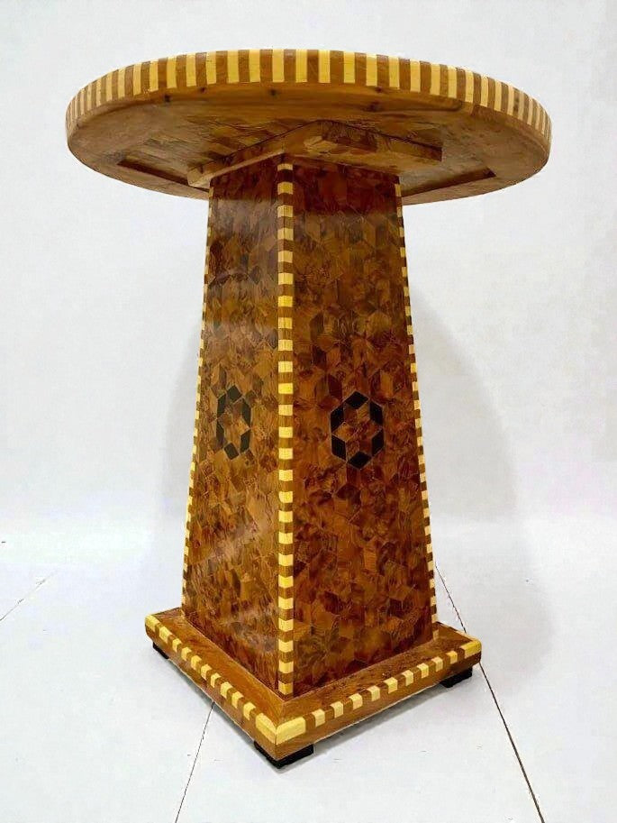 AtlasMuseCrafts handmade Moroccan solid wood dining table with intricate geometric inlay on the pedestal base and striped wood edge.