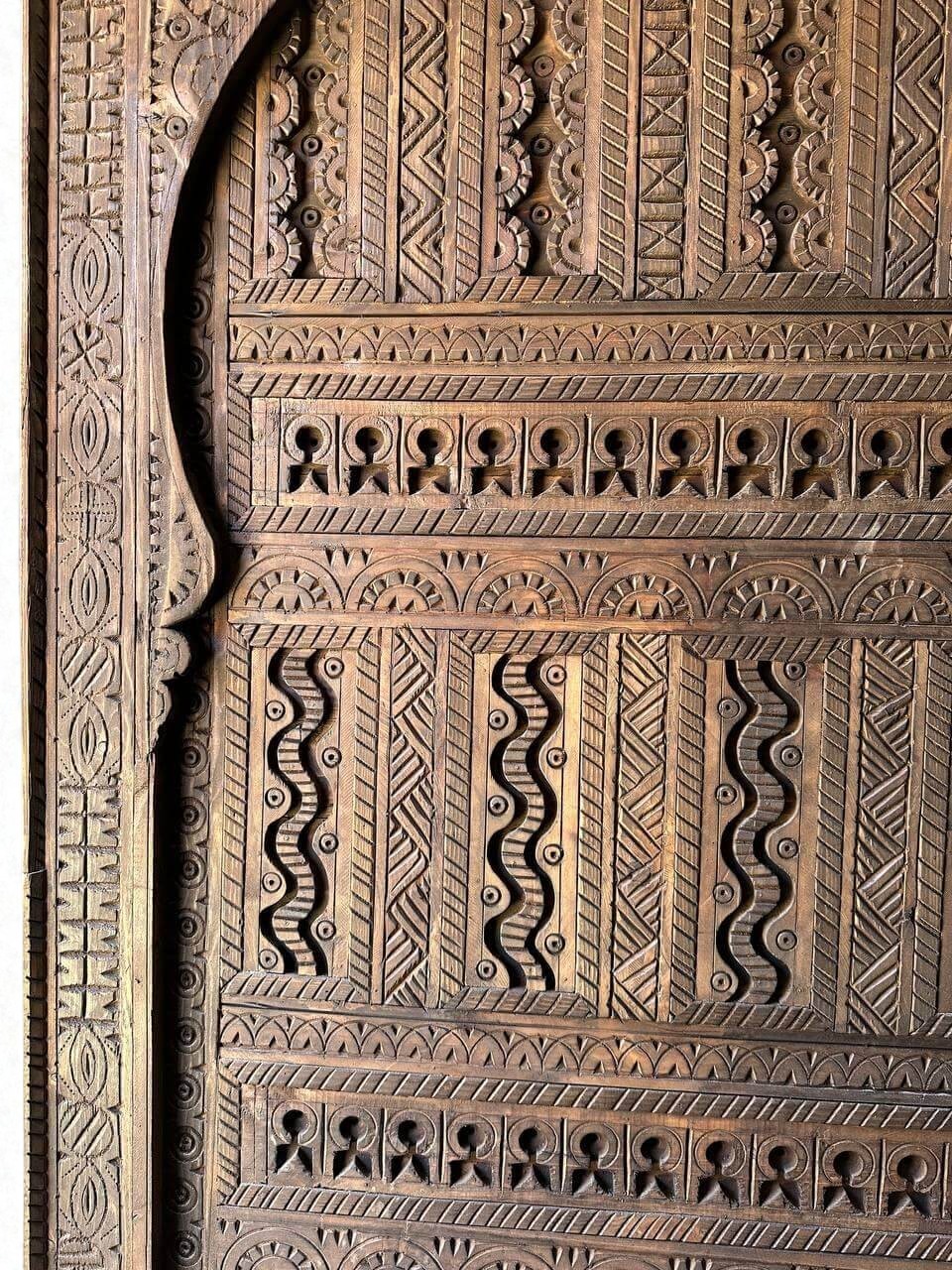 AtlasMuseCrafts custom Moroccan handmade wood door with intricate geometric carvings. Natural wood finish.