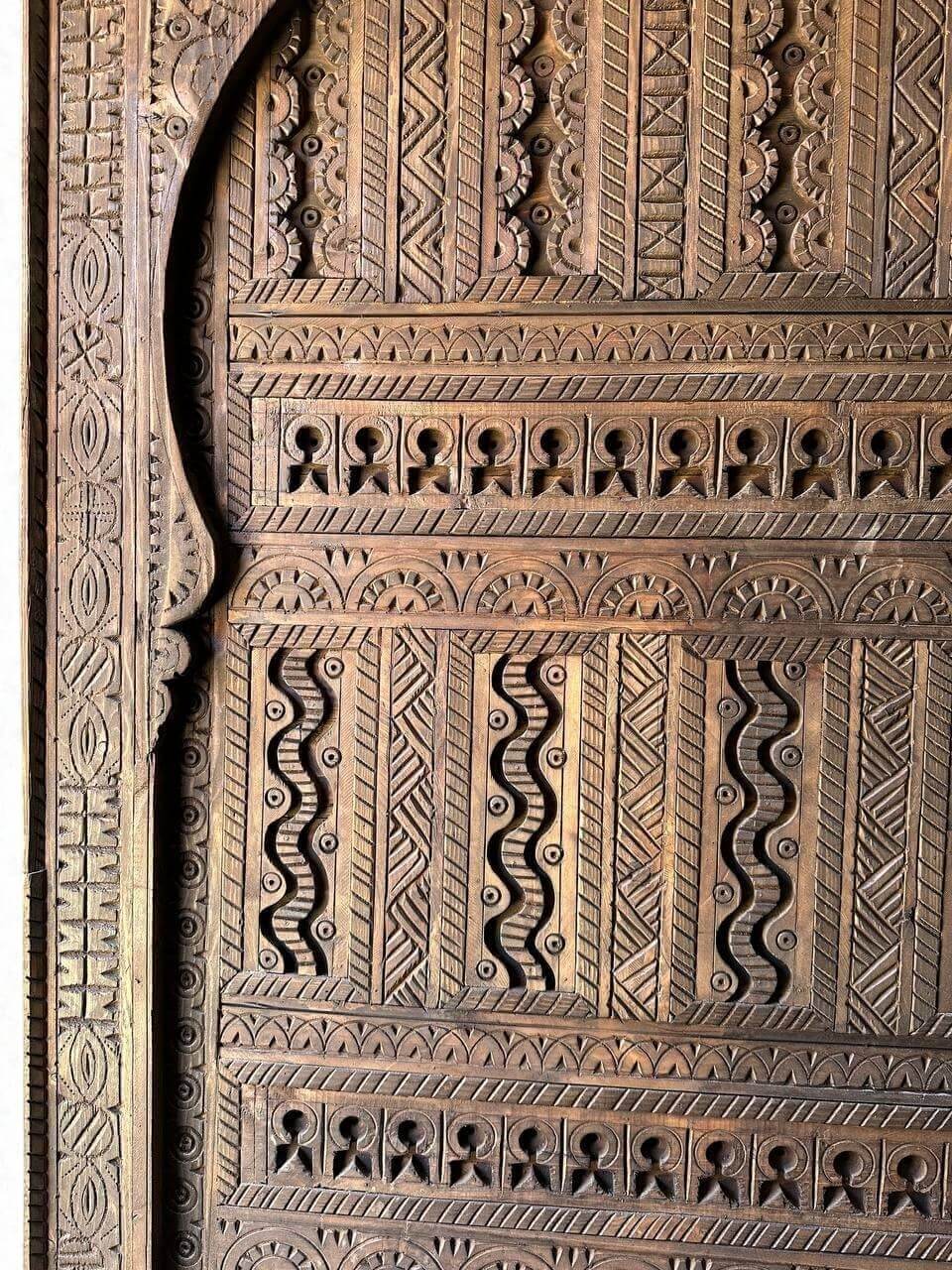 AtlasMuseCrafts custom Moroccan handmade wood door with intricate geometric carvings. Natural wood finish.