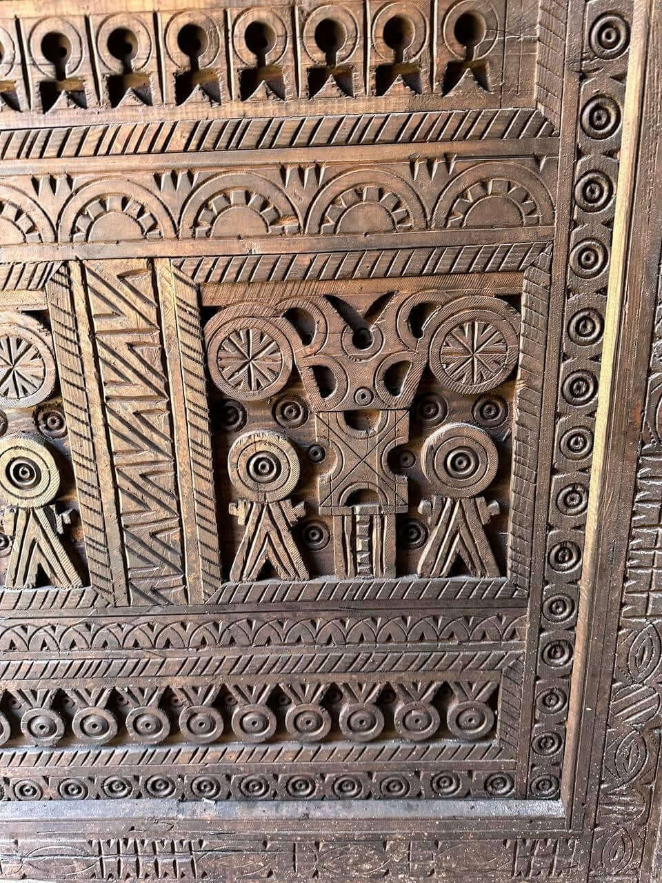 AtlasMuseCrafts custom Moroccan handmade wood door with intricate geometric carvings. Natural wood finish.