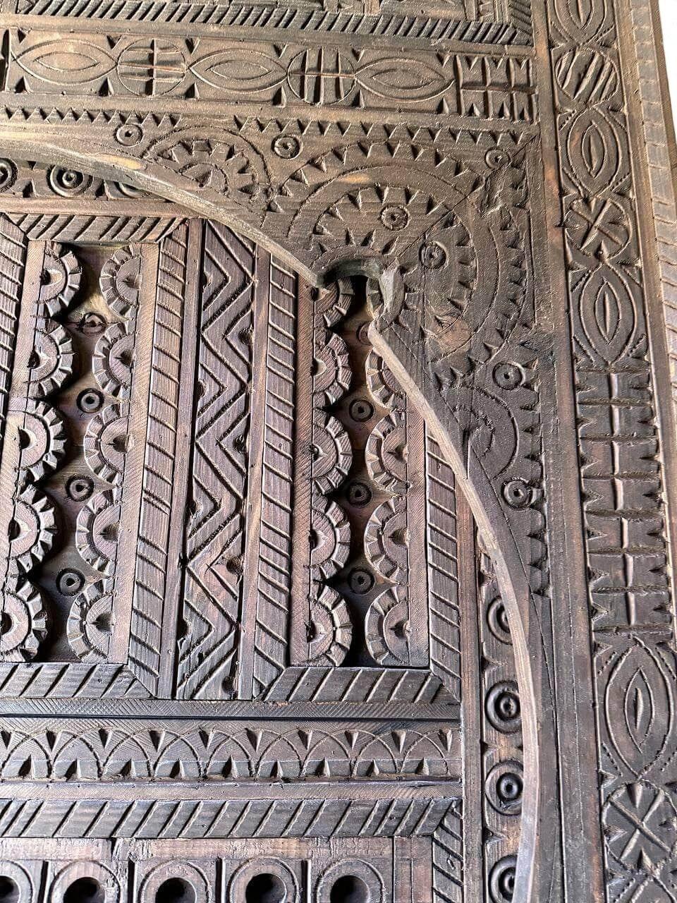 AtlasMuseCrafts dark wood Moroccan door with intricate geometric hand-carving, suitable for indoor or outdoor use.