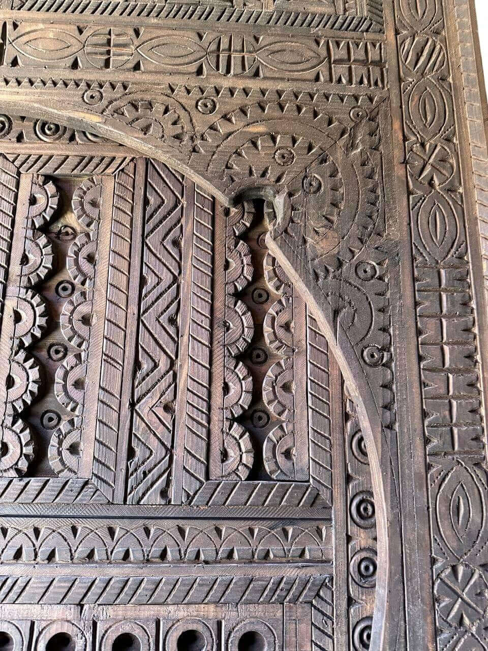 AtlasMuseCrafts dark wood Moroccan door with intricate geometric hand-carving, suitable for indoor or outdoor use.