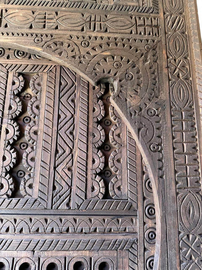 AtlasMuseCrafts dark wood Moroccan door with intricate geometric hand-carving, suitable for indoor or outdoor use.