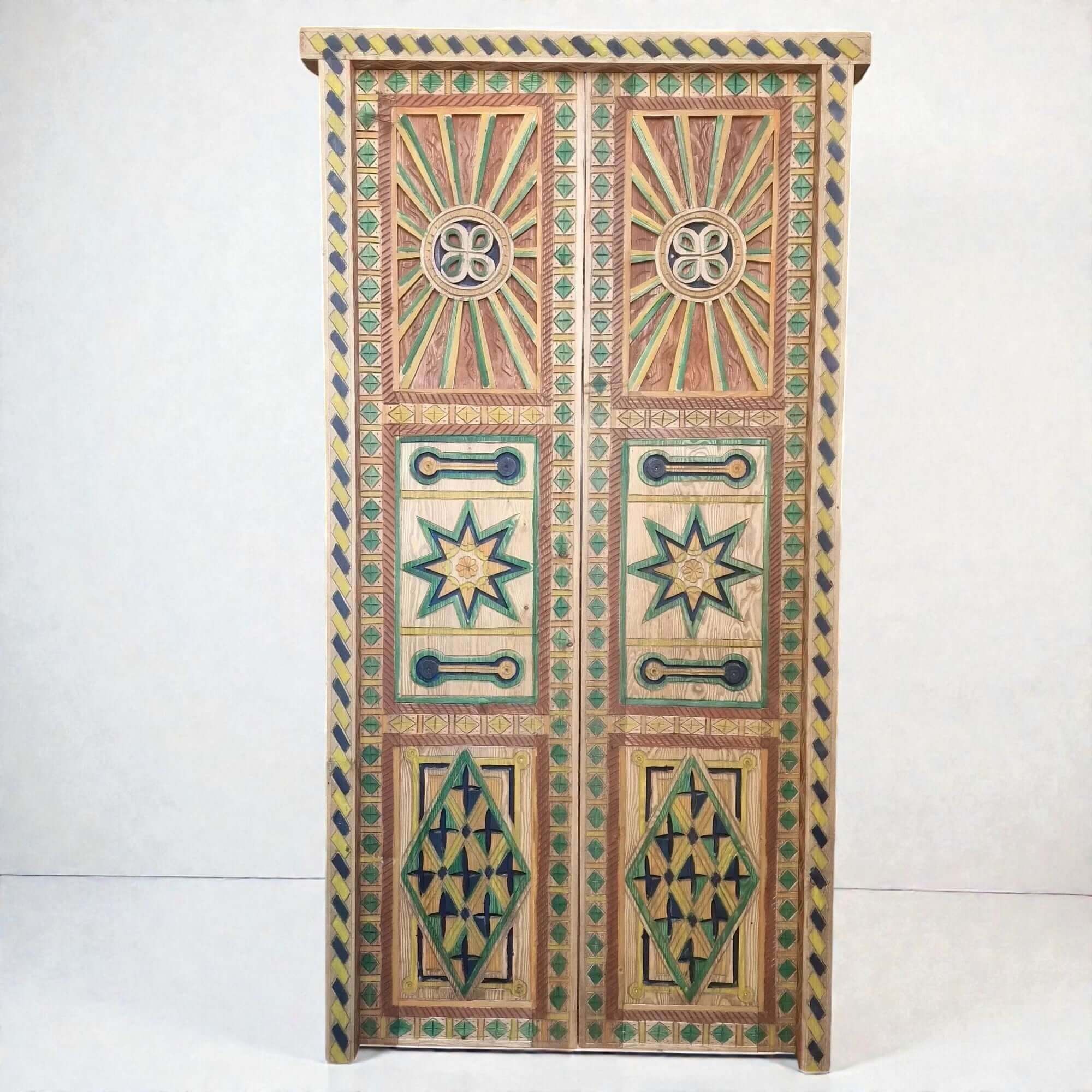 AtlasMuseCrafts hand-painted multicolor Moroccan wood door with geometric carving and sunburst motifs.