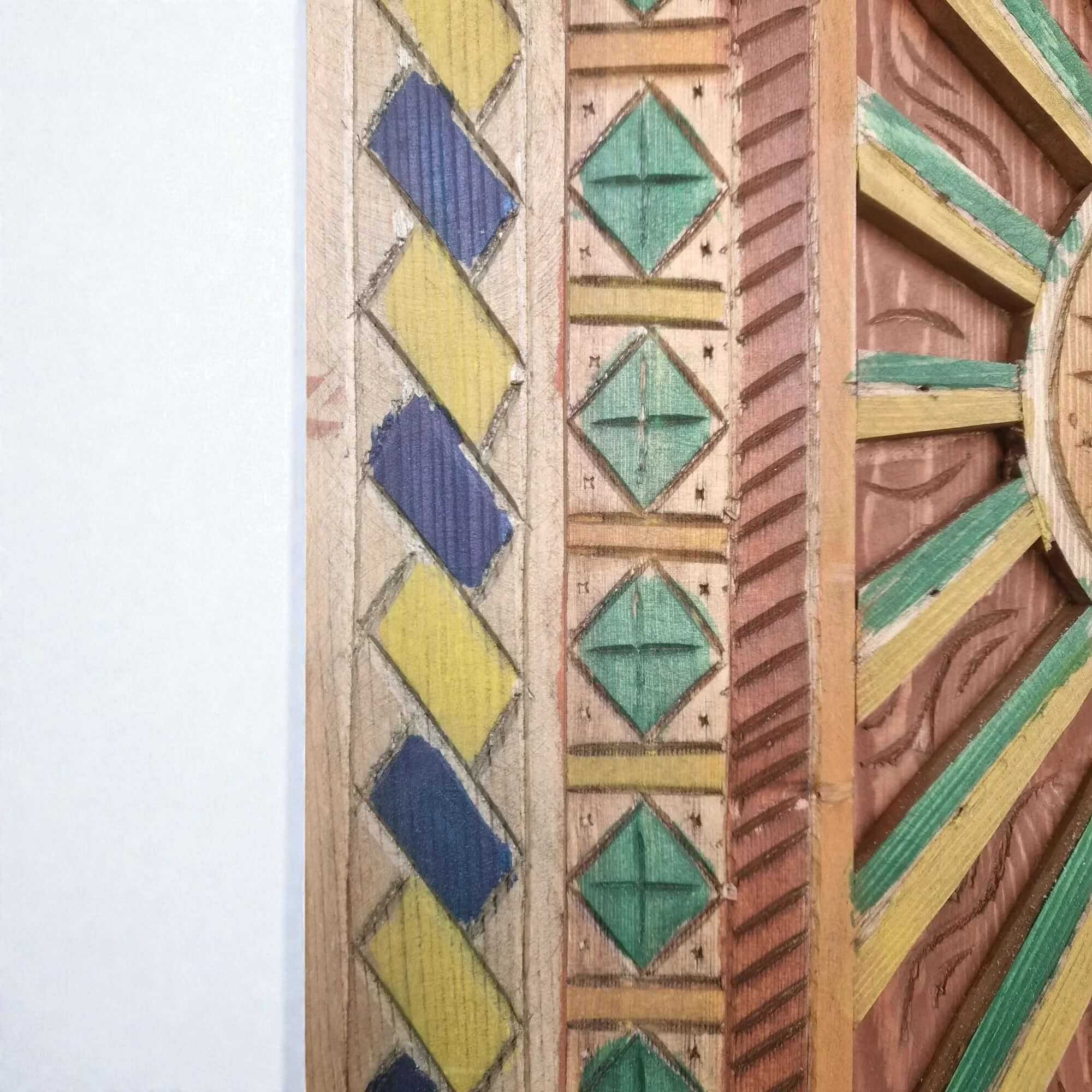 AtlasMuseCrafts hand-painted multicolor Moroccan door with geometric carving in blue, yellow, green, and red wood.
