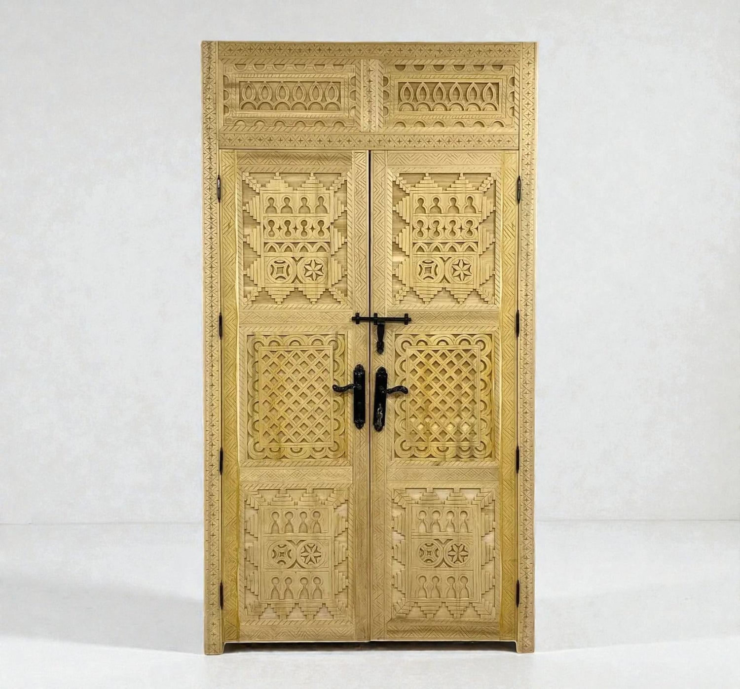 AtlasMuseCrafts natural wood double door with intricate Berber geometric carvings and black hardware.