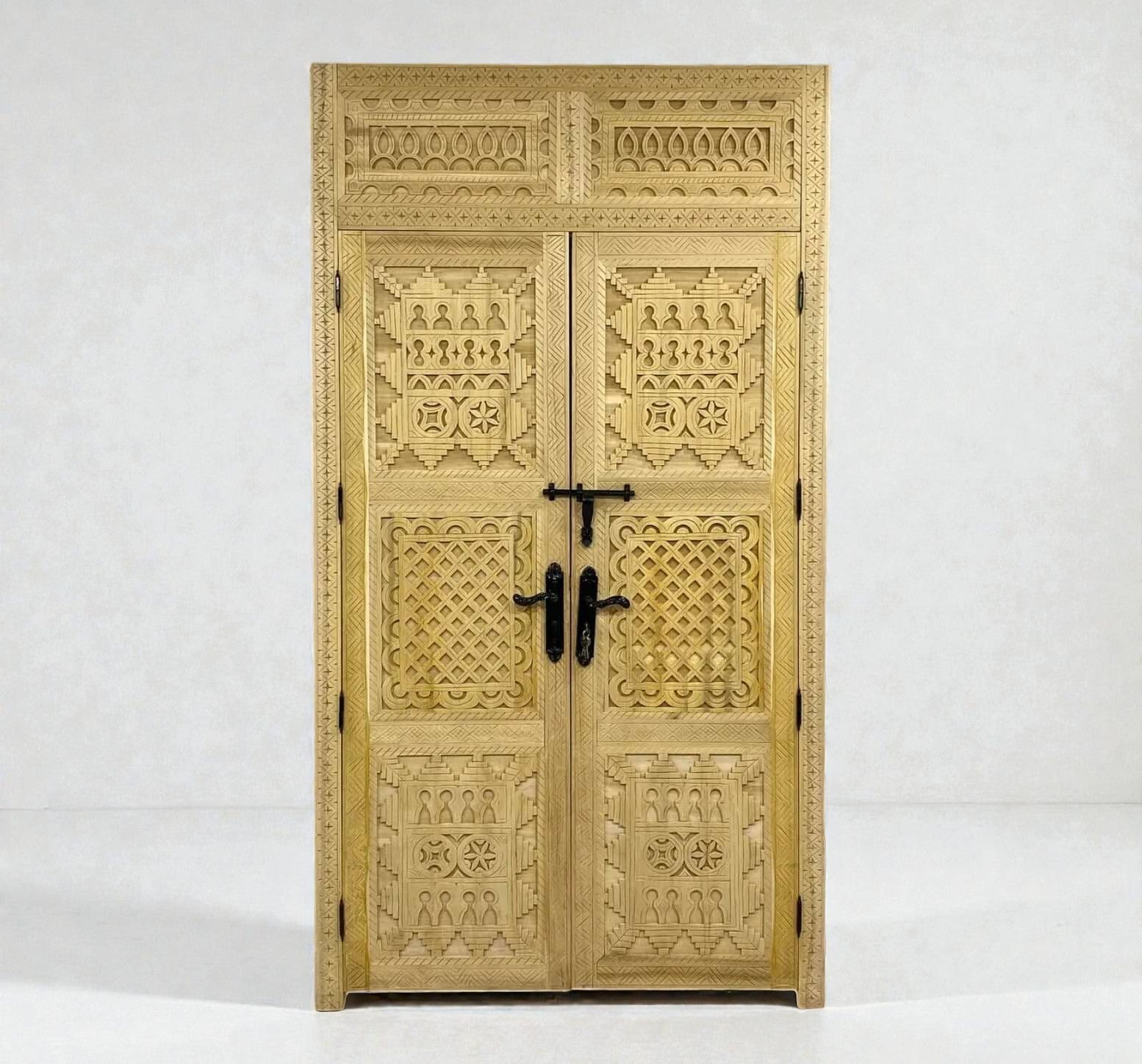 AtlasMuseCrafts natural wood double door with intricate Berber geometric carvings and black hardware.