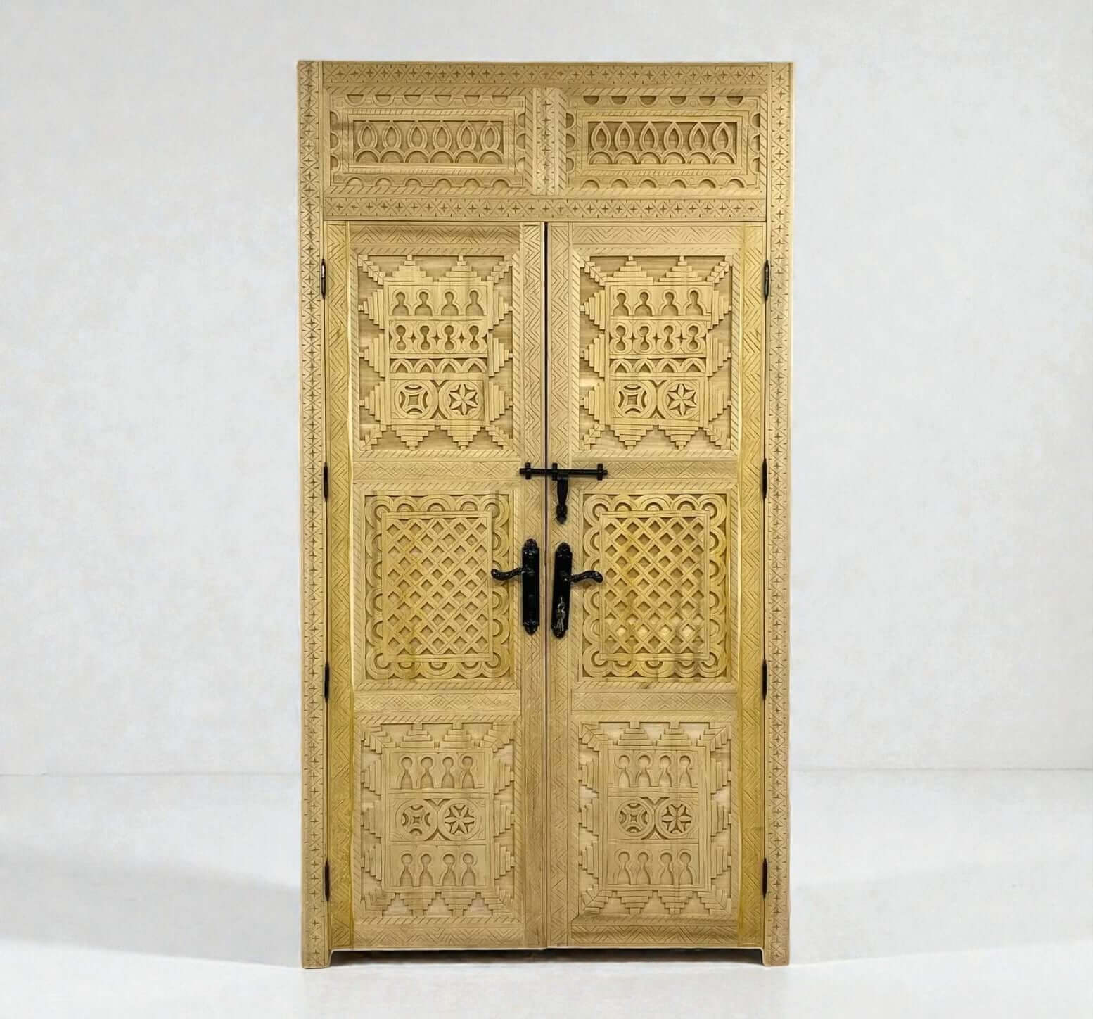 AtlasMuseCrafts natural wood double door with intricate Berber geometric carvings and black hardware.