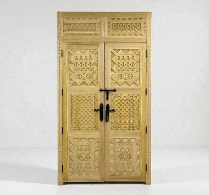 AtlasMuseCrafts natural wood double door with intricate Berber geometric carvings and black hardware.