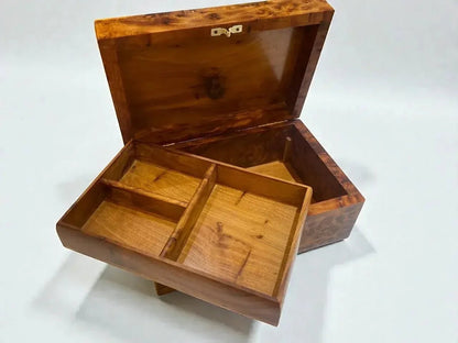 AtlasMuseCrafts handmade Moroccan Thuya wood jewelry box with a removable tray and unique swirling grain pattern.