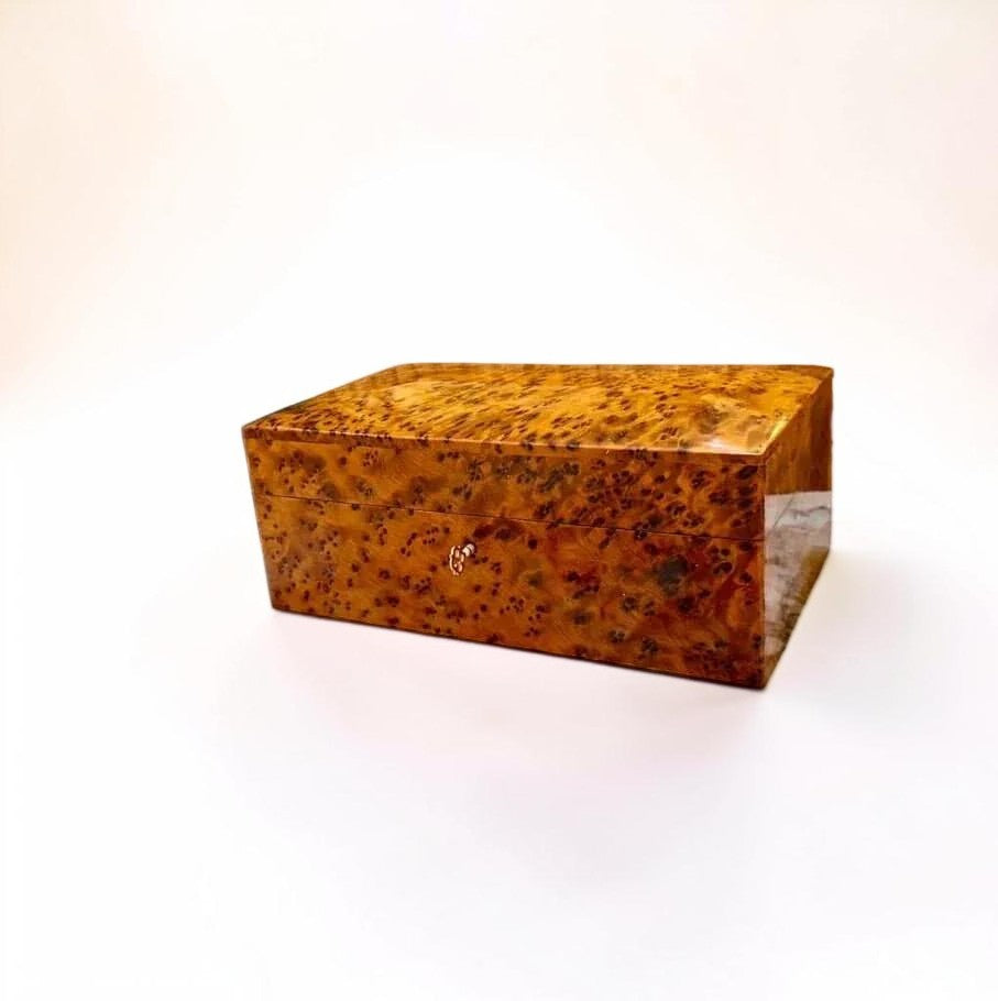 AtlasMuseCrafts lockable jewelry box crafted from polished Moroccan Thuya burl wood with a brass key lock.
