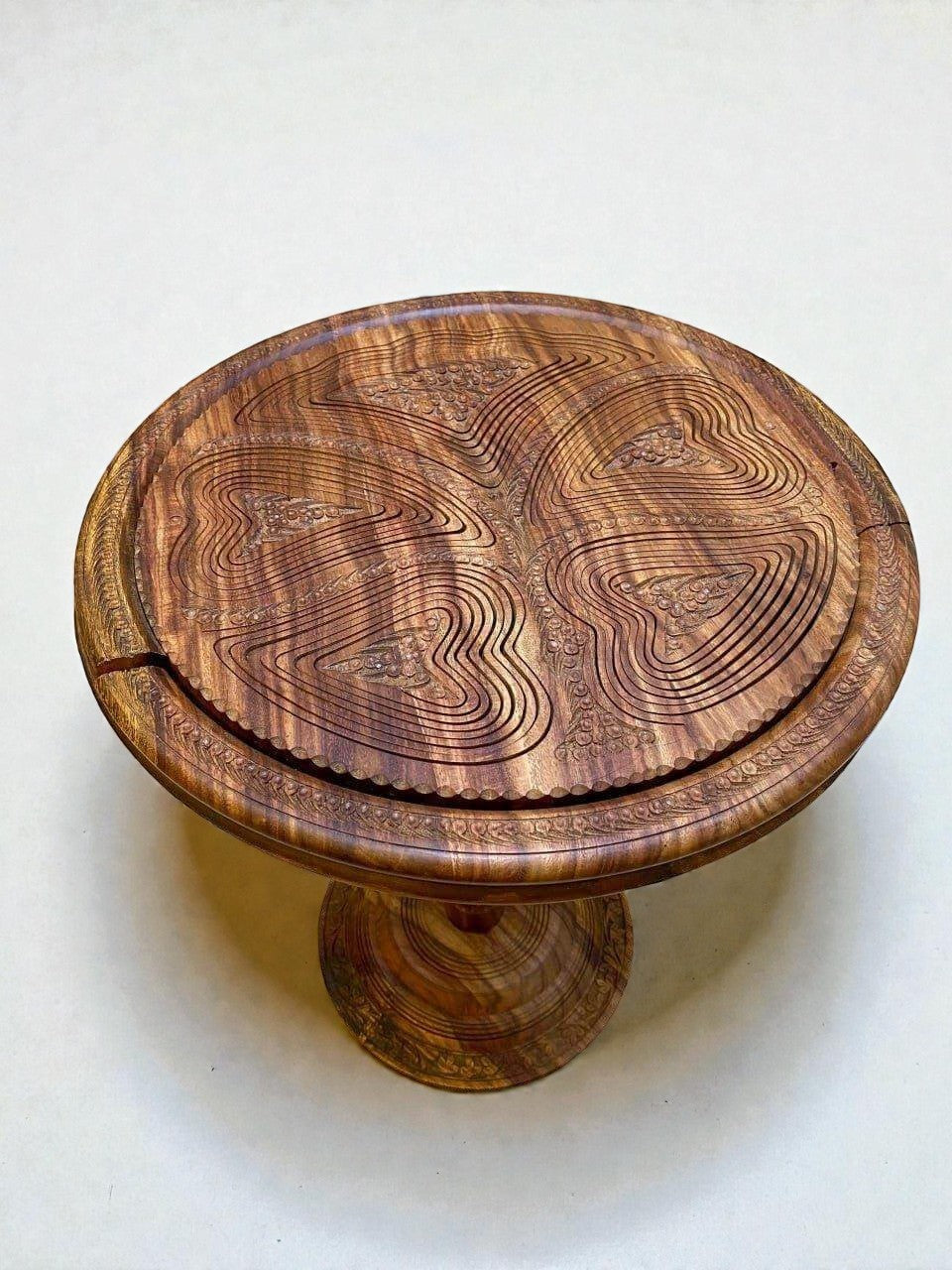 AtlasMuseCrafts handmade solid walnut coffee table with intricate carved topographic design and warm natural finish.