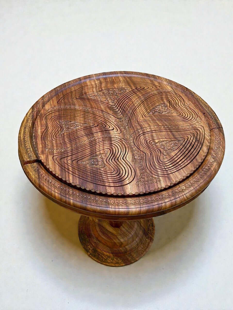Walnut coffee table with carved top design and warm natural finish