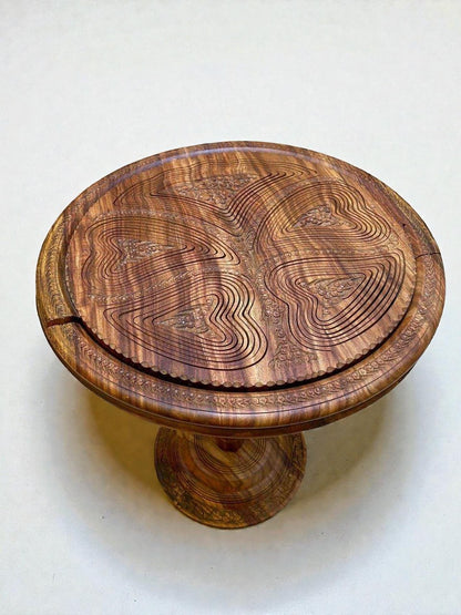 AtlasMuseCrafts handmade solid walnut coffee table with intricate carved topographic design and warm natural finish.