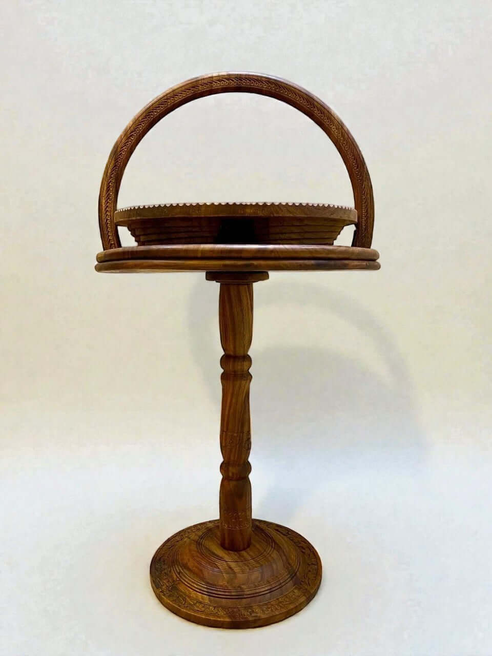 Solid walnut tiered display stand with carved details and curved handle