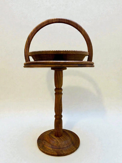 AtlasMuseCrafts handmade solid walnut tiered display stand with carved details and a curved handle.