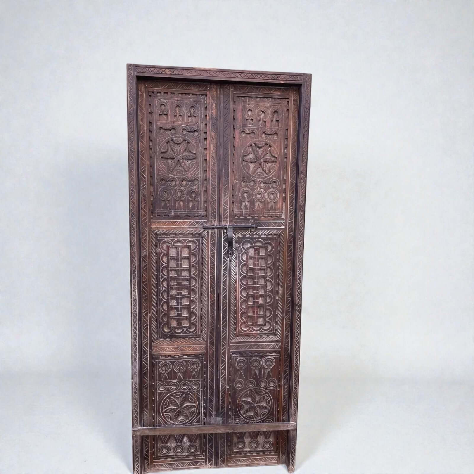 AtlasMuseCrafts dark wood double panel door with intricate geometric carvings. Ideal for grand entryways.