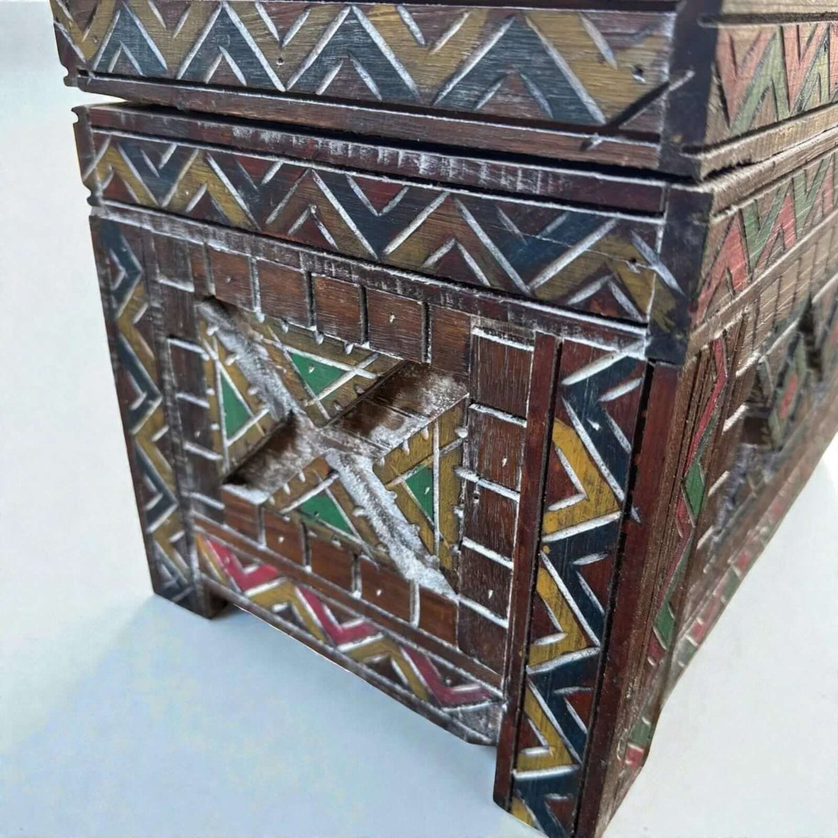 AtlasMuseCrafts handmade wooden cabinet with carved Berber patterns in red, yellow, green, and white. Rustic boho style.
