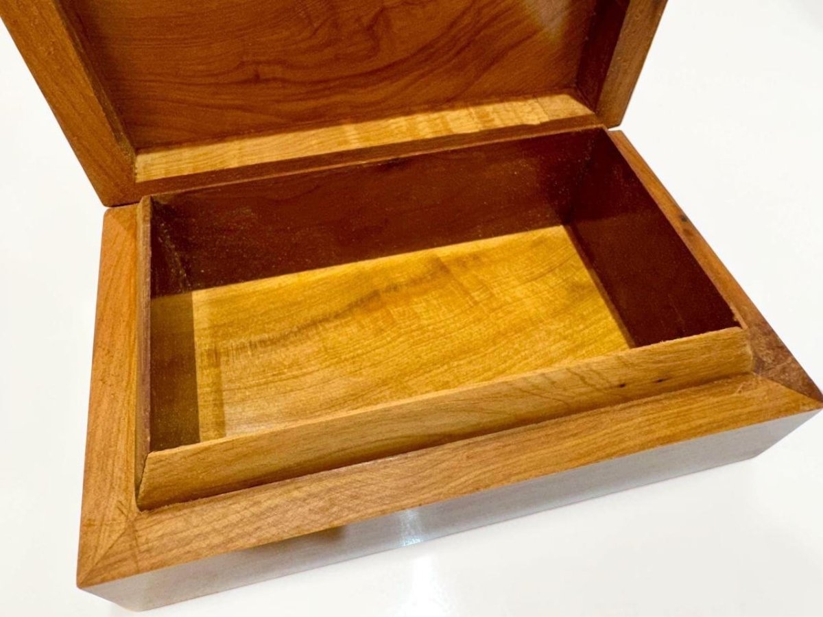 Open burl wood jewelry organizer showing Thuya grain and compartments