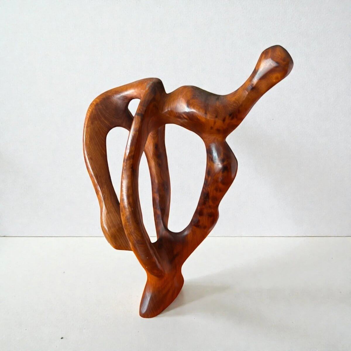 Handmade contemporary wood sculpture with flowing abstract form