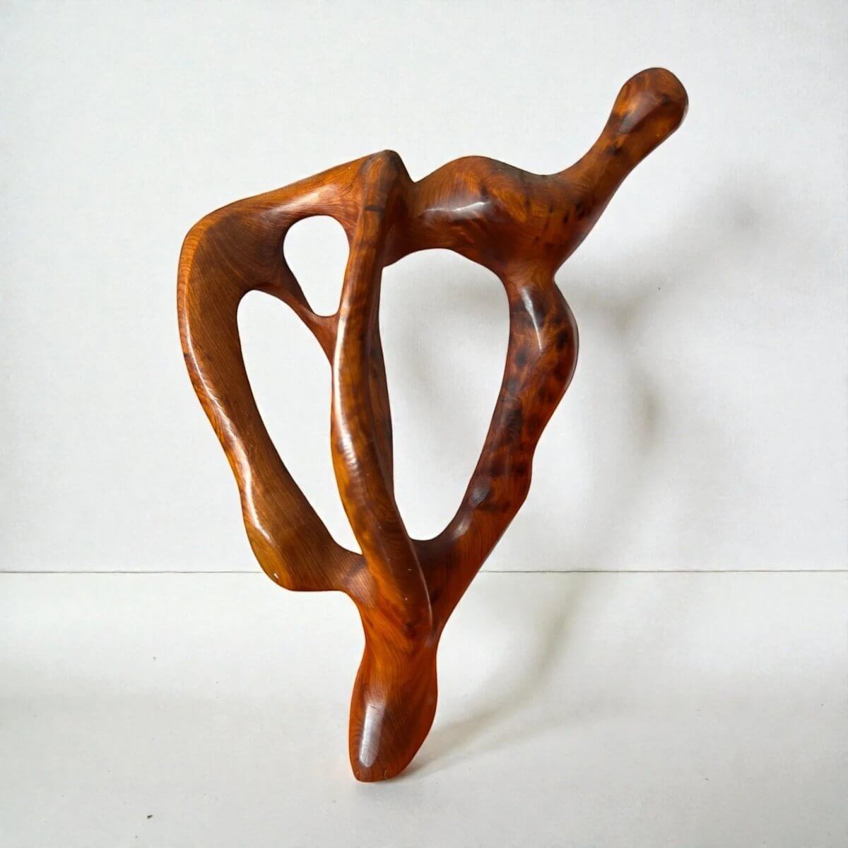Abstract wood sculpture with polished natural openwork design