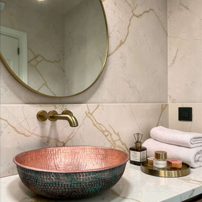Green Patina Brass Vessel Sink displayed in a stylish bathroom with modern fixtures and elegant decor.
