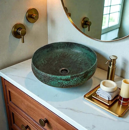 Coppera Studio green patina copper vessel sink with hammered texture and dark speckles. Round bowl design.