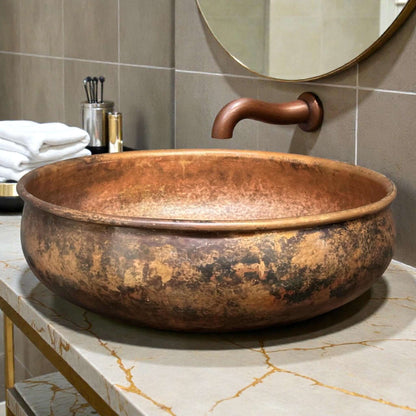 Hammered Copper Bathroom Sink elegantly displayed on a countertop with modern faucet and accessories.