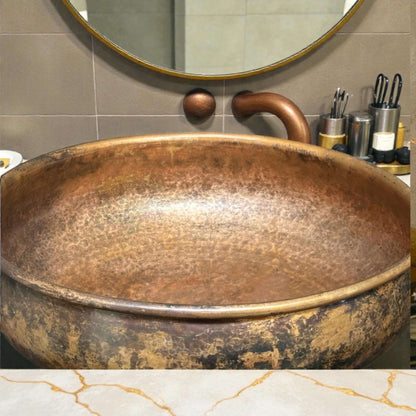 Hammered Copper Bathroom Sink showcased in a stylish bathroom with elegant decor and accessories.