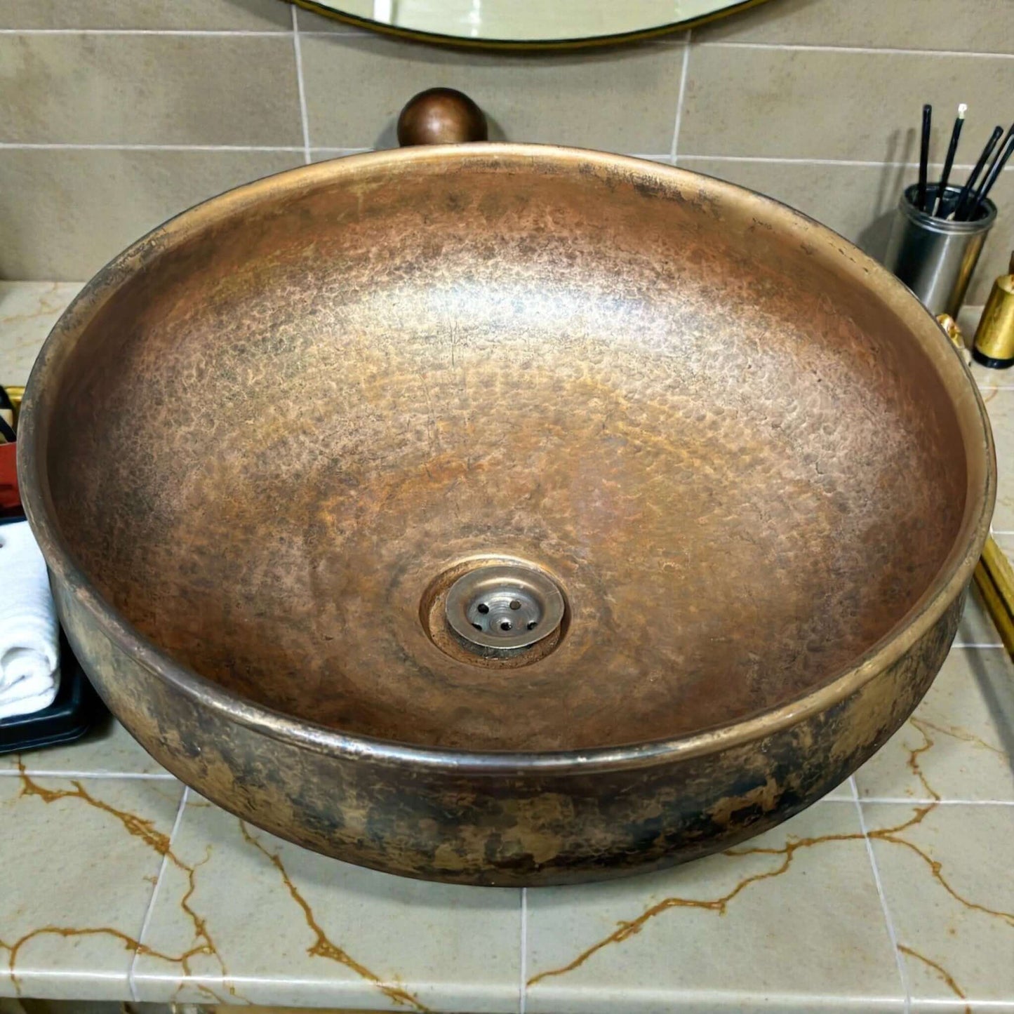 Hammered Copper Bathroom Sink in a stylish bathroom setting with a modern design and rustic appeal.