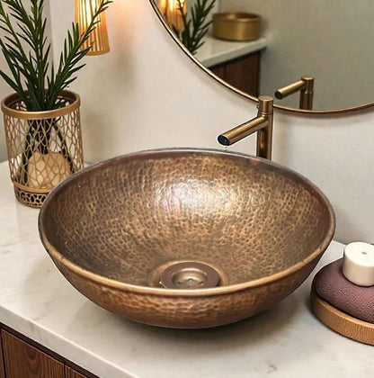 Coppera Studio handmade copper vessel sink with hammered texture and brass faucet.