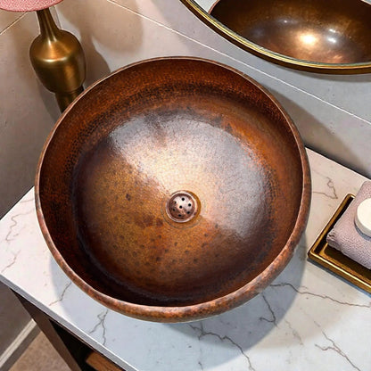 Hammered Brown Copper Vessel Sink displayed on a marble countertop with modern bathroom fixtures.